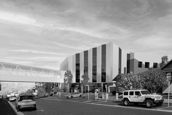 Northern Mental Health Precinct exterior on Frankland Street showing multi‑storey building, landscaped forecourt and pedestrian link to hospital.