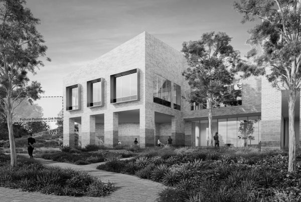 North West Mental Health Precinct ground floor entry showing articulated brick façade, shaded walkway and landscaped approach.